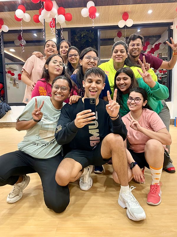 Jay taking a group selfie with members